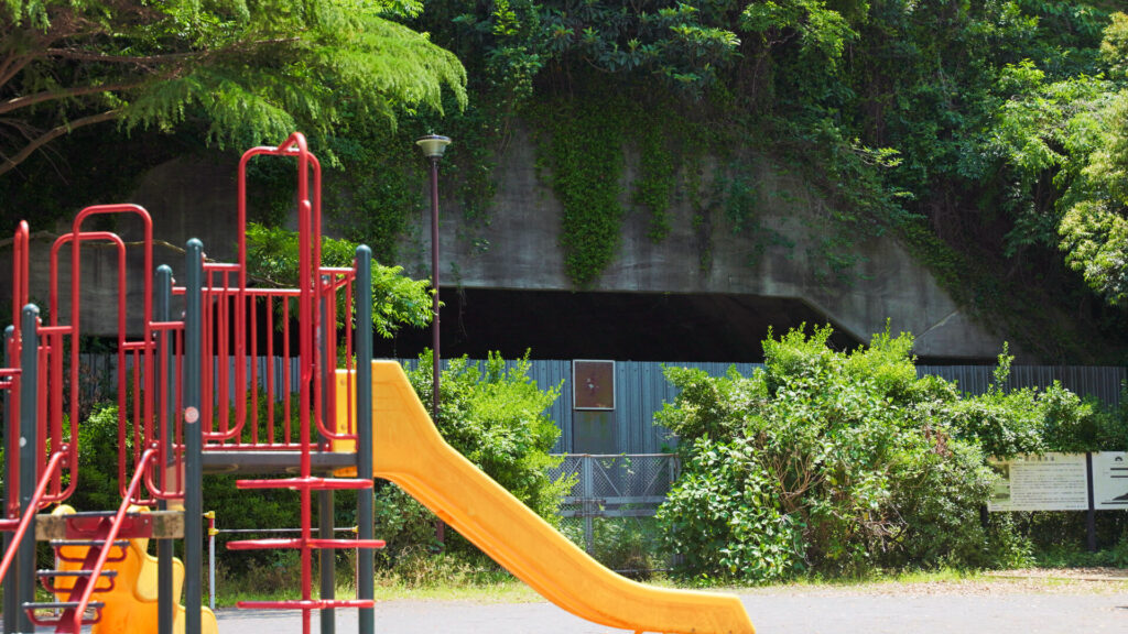Playground equipment in the park with the Nojima Aircraft Bunker behind